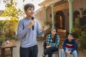 Varanasi student practising school morning assembly anchoring at home